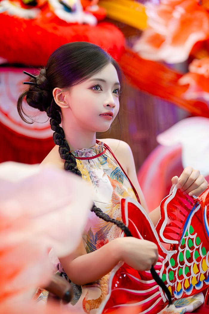 Young woman participates in traditional Chinese dragon dance, showcasing vibrant costume and cultural heritage.